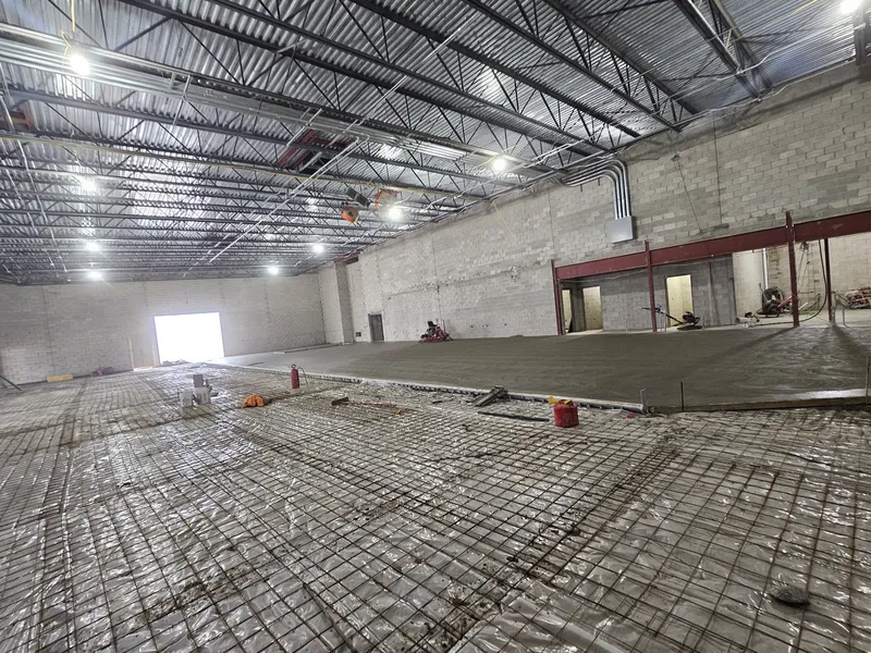 Large commercial warehouse concrete floor with reinforcing mesh during placement