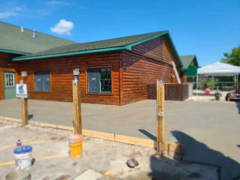 Concrete slab and approach poured at a commercial log building