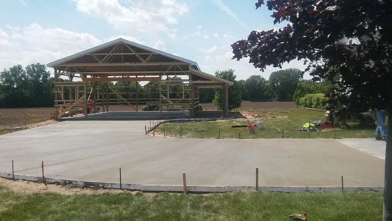 Concrete slab poured under a pavilion during framing