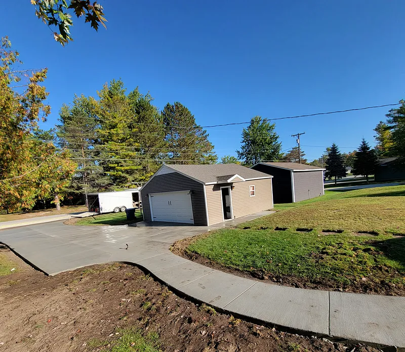 Concrete driveway and connecting sidewalk at a Mid-Michigan home