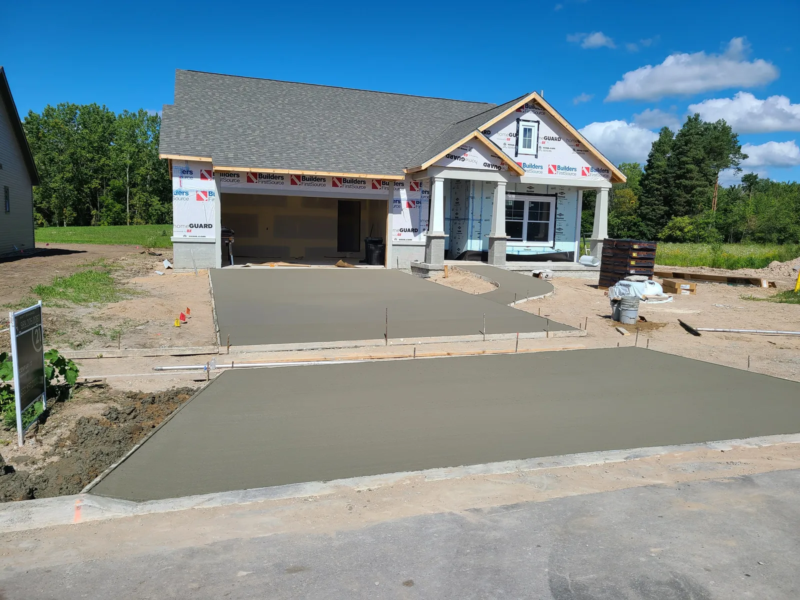 Concrete driveway at a newly built craftsman-style home in Mid-Michigan