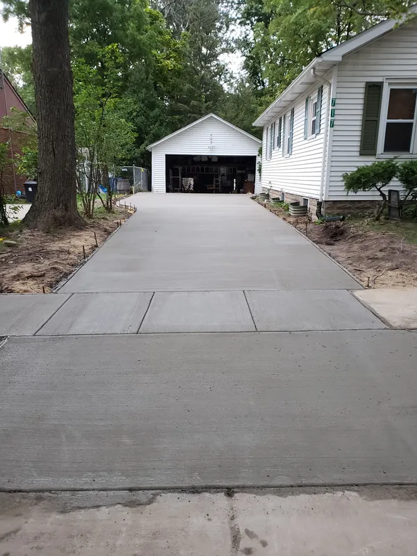Concrete driveway serving a detached garage on a Mid-Michigan lot