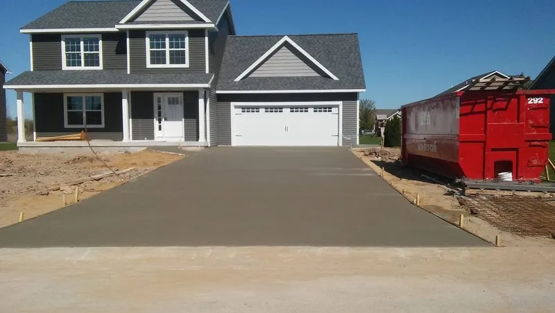 Concrete driveway at a gray two-story home in Mid-Michigan