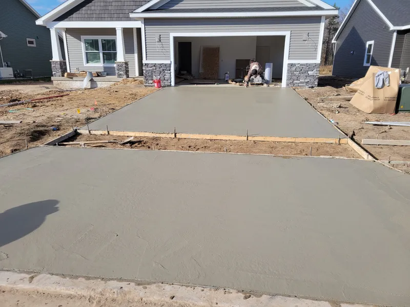 New concrete driveway at a craftsman-style home build in Mid-Michigan