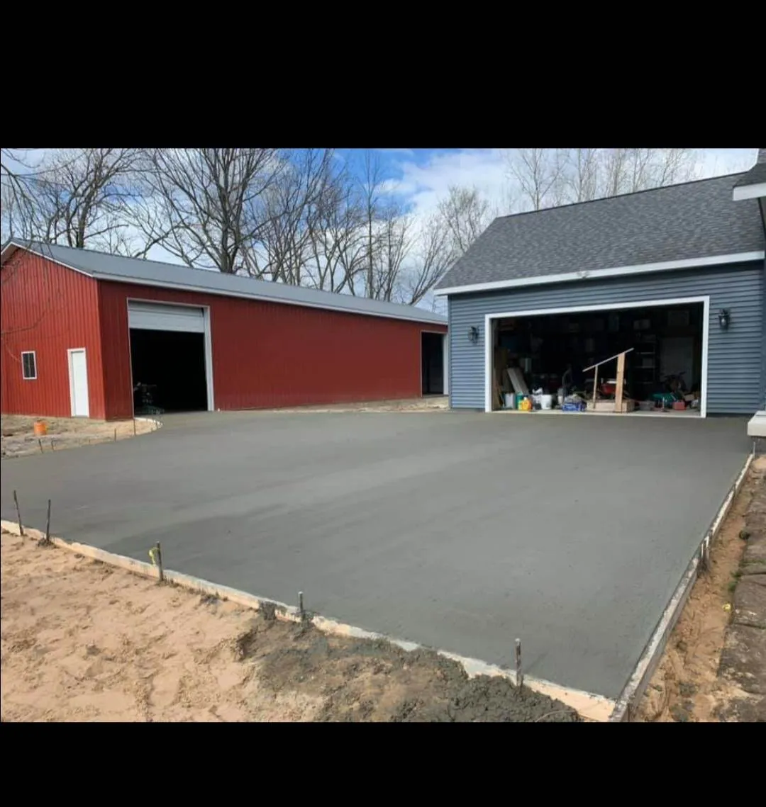 Concrete drive and pad between a house and pole barn in rural Michigan