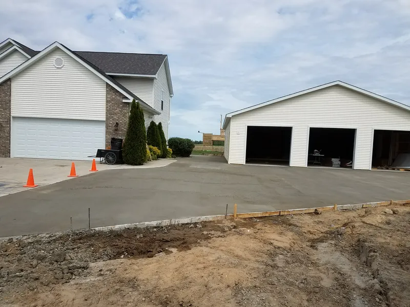 Concrete driveway and apron leading to a pole barn on a rural Mid-Michigan property