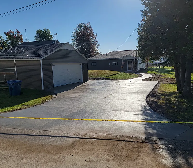 Concrete driveway serving a ranch home and detached garage