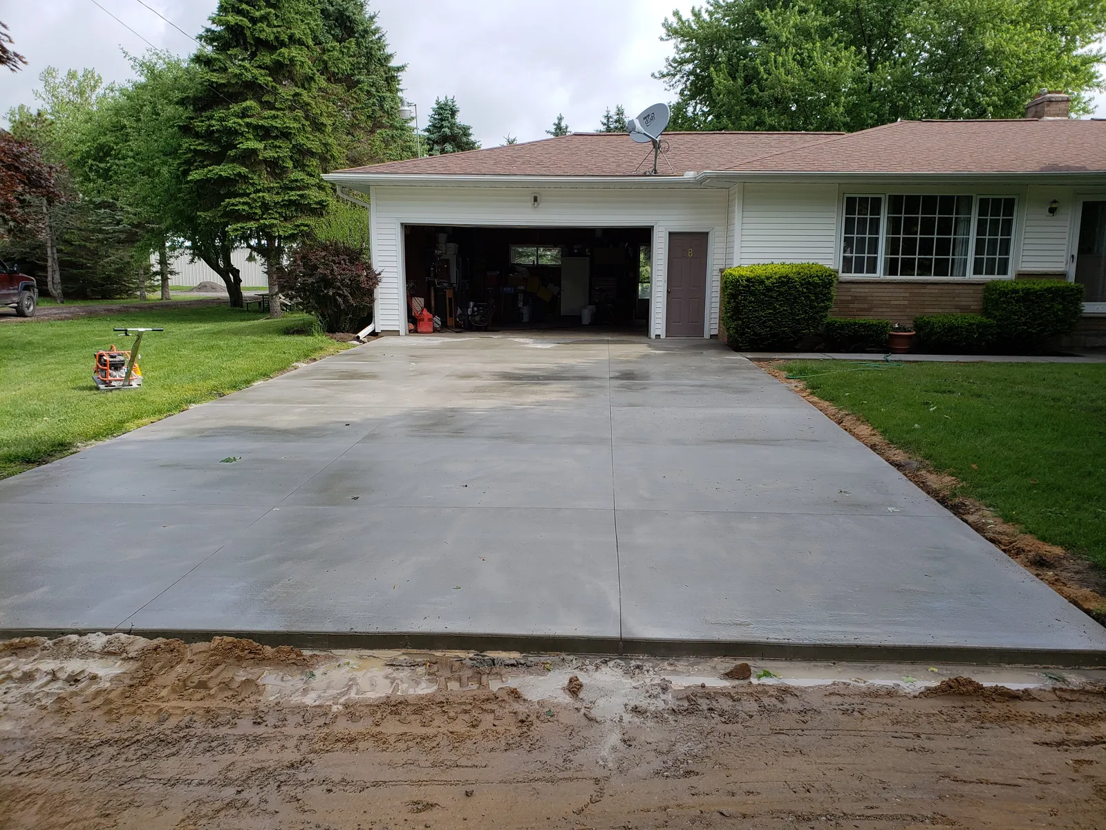 Broom-finished concrete driveway at a single-story ranch home near Bay City, Michigan