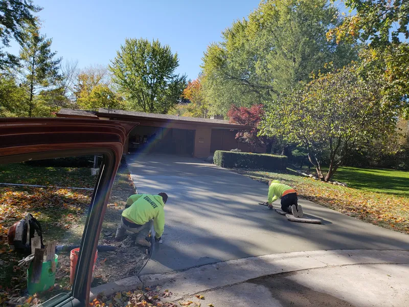 Merchant American Concrete crew finishing a residential driveway pour
