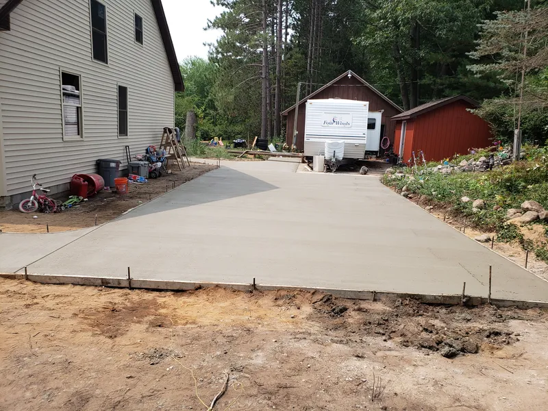 Concrete driveway with an added side parking slab at a Mid-Michigan home