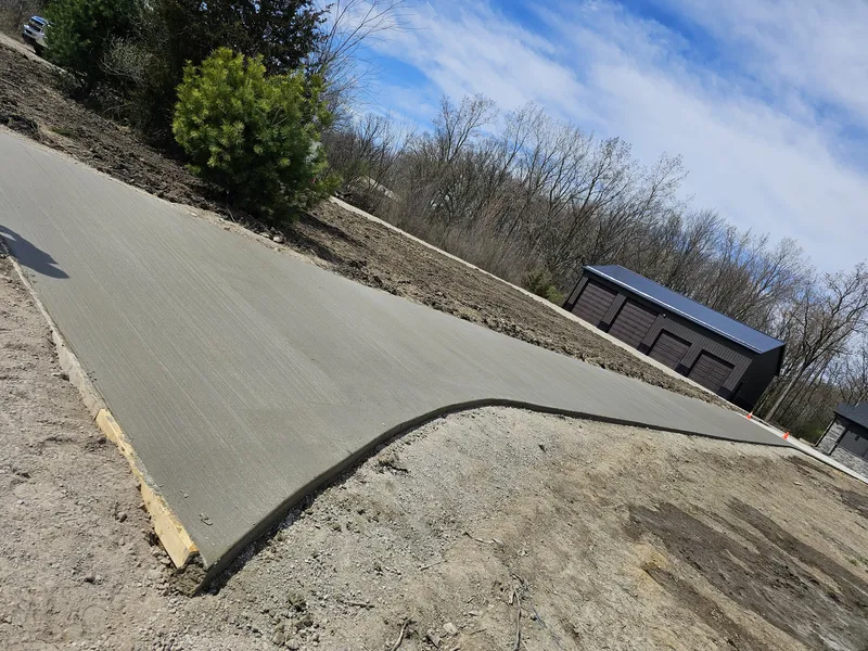 Concrete driveway on a sloped approach to a Mid-Michigan home