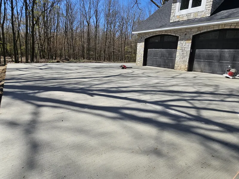 Concrete driveway to the garage of a stone-accented home