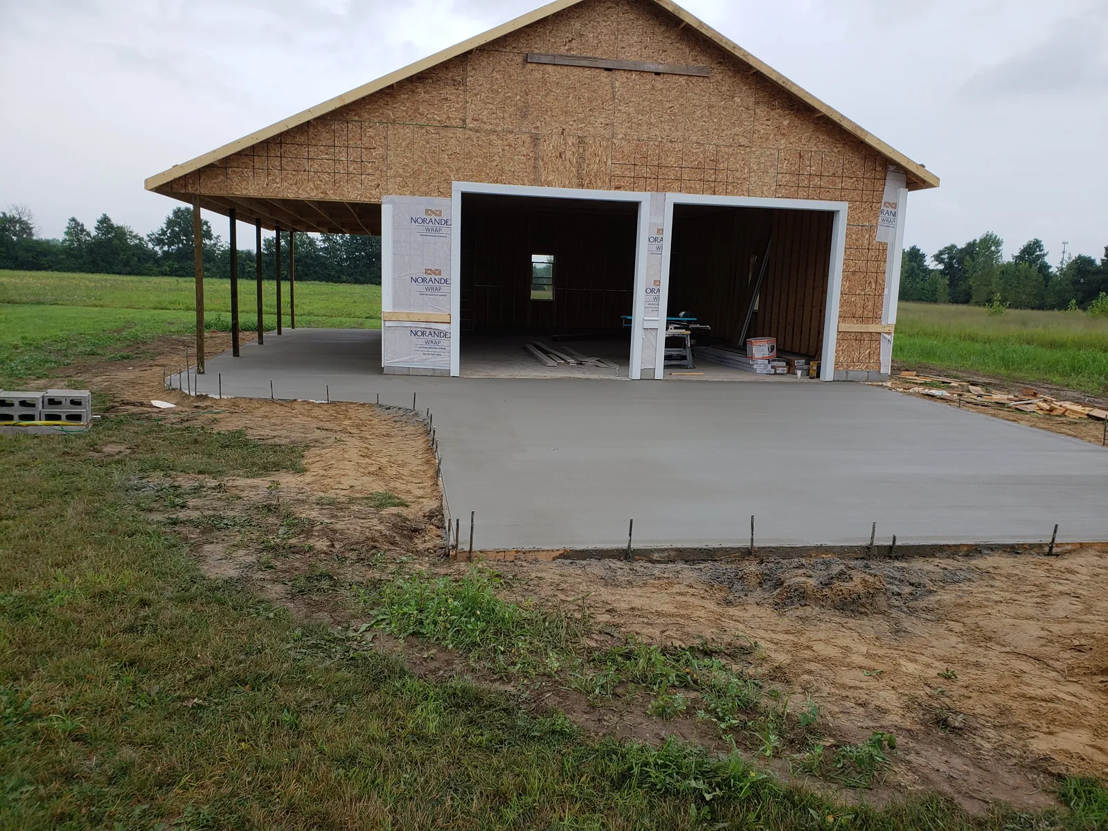 Freshly poured concrete garage apron during placement at a Mid-Michigan home