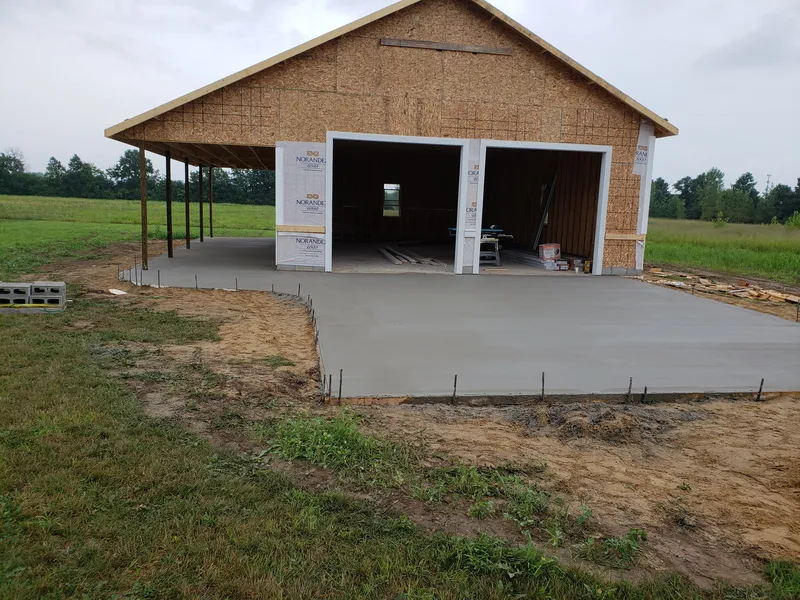 Freshly poured concrete garage apron during placement at a Mid-Michigan home