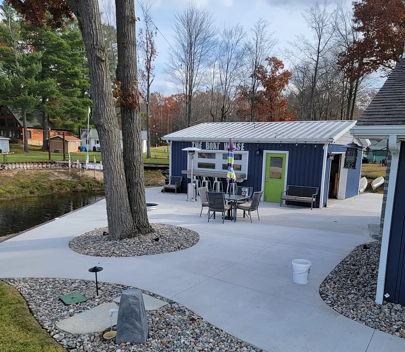 Concrete patio beside a lakeside boat house in Mid-Michigan