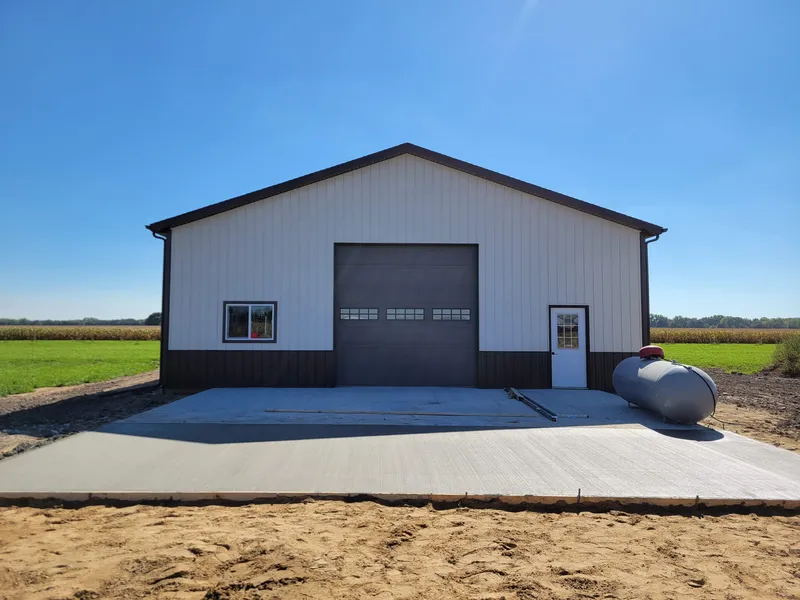 Concrete apron at a pole barn on an open rural field