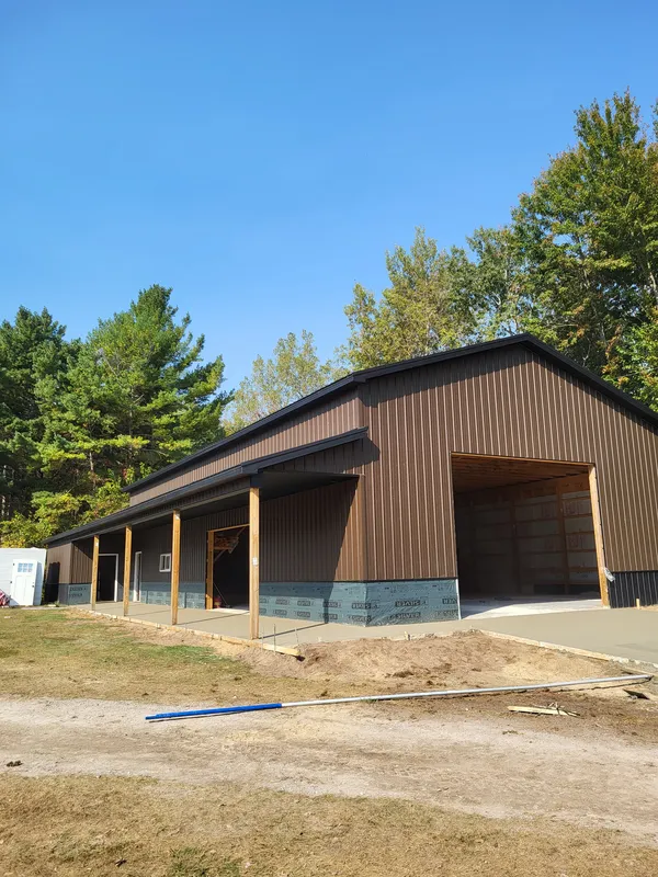 Concrete apron at a brown steel pole barn in Mid-Michigan