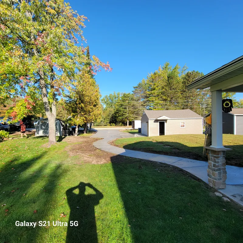 Curved concrete sidewalk leading to a covered front porch