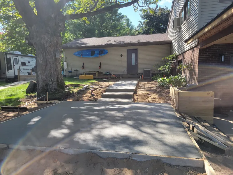 Concrete front walkway leading to a home's entrance