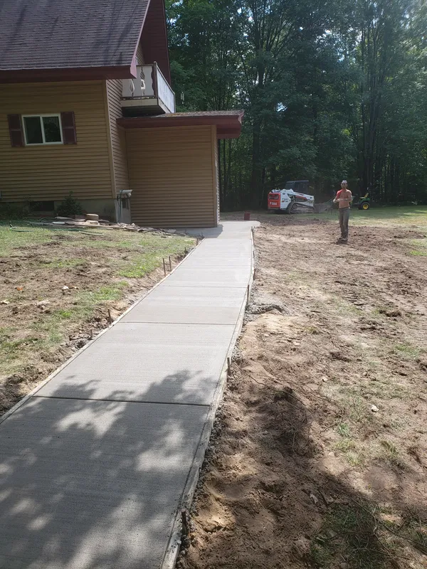 Concrete walkway running along the side of a residential home