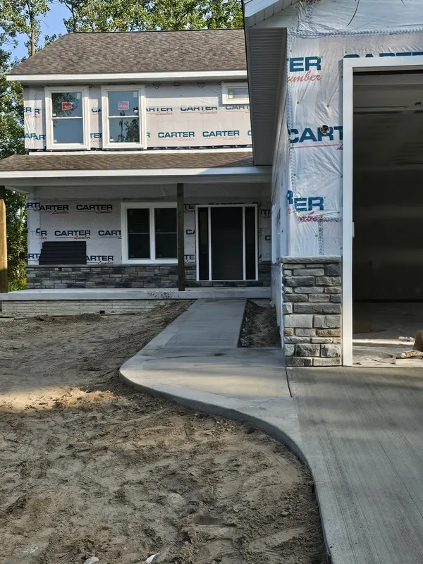 Concrete sidewalk leading to a home's front porch