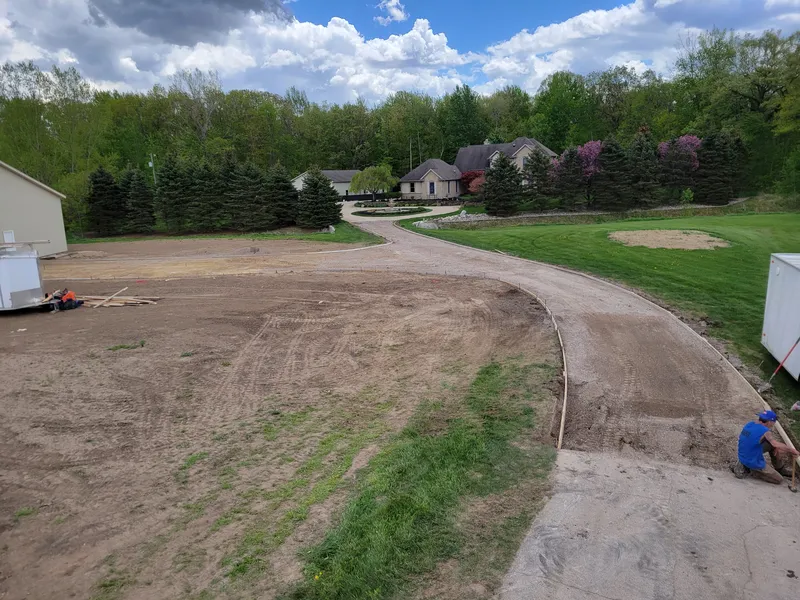 Site grading and base prep before a Mid-Michigan concrete driveway pour