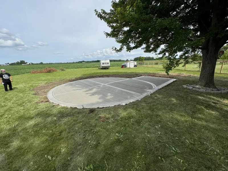 Oval concrete sport court slab poured in a residential yard